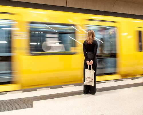 A person waiting calmly at a public transport stop